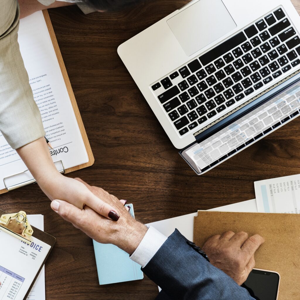 business people shaking hands together